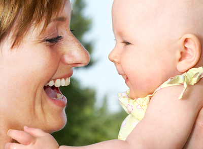 Woman laughing with a baby