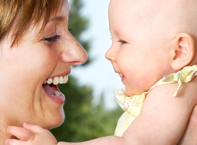 Woman laughing with a baby