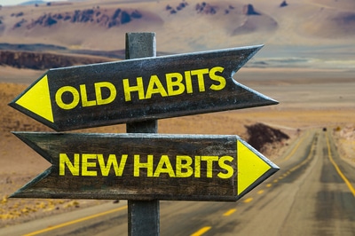 Wooden highway signs Old Habits and New Habits.