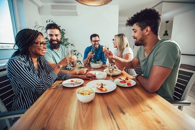 Group of people eating together at a large table.