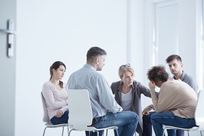 Addiction recovery group meeting in a circle.