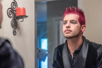 Man looking at himself in a mirror.