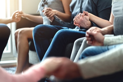 Group of people holding hands.