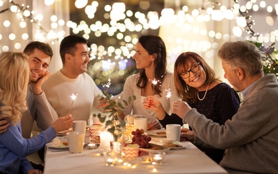 Group of people sitting around a dinner table.