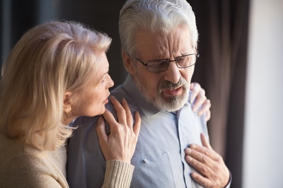 Woman comforting a man appearing in pain.
