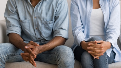 People sitting with hands crossed.