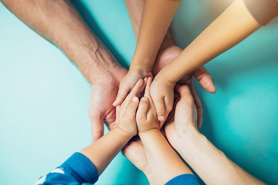 Group of people holding hands.