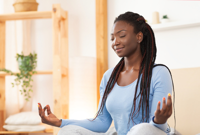 Woman sitting in a meditative pose.