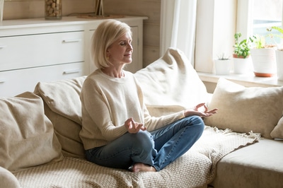 Woman sitting in a meditative posture.