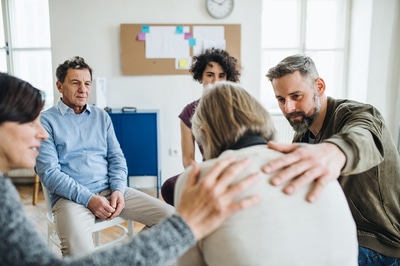 Group of people meeting in a circle.