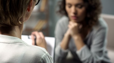 Woman sitting with a therapist.