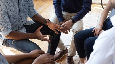 Group of people meeting in a circle.