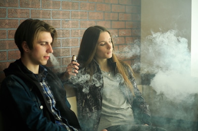 Two teens vaping.