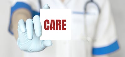 Medical technician holding a note labeled care.