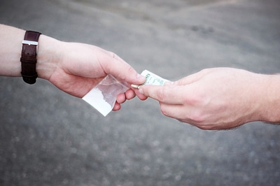 Purchasing drugs with cash.