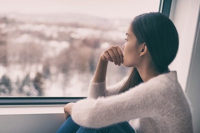 Looking out a window.