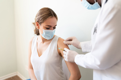 Person getting a covid-19 vaccination