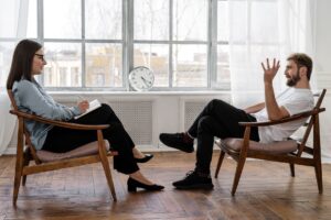 A man and a woman in a counseling session at one of the best drug rehab centers